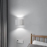 Alpha Lights black aluminium wall light in garden setting